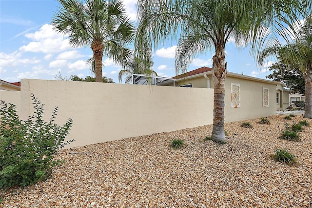 1323 Balboa Ct, The Villages, FL 32159 - view of property exterior featuring stucco siding and fence