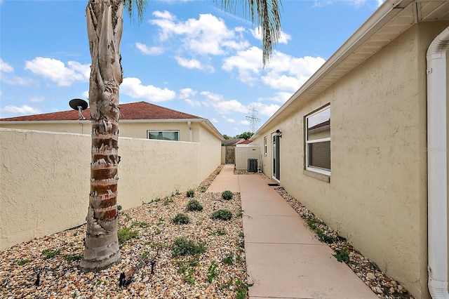 1323 Balboa Ct, The Villages, FL 32159 - view of side of property with fence, stucco siding, and cooling unit