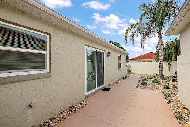 1323 Balboa Ct, The Villages, FL 32159 - view of property exterior with fence, stucco siding, and a patio area