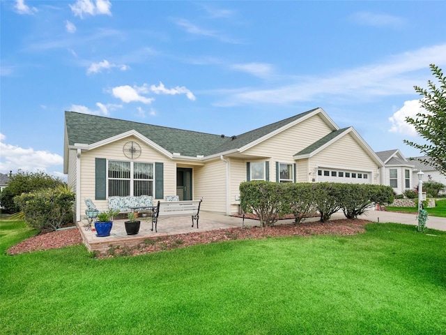 ranch-style home featuring roof with shingles, a front lawn, concrete driveway, and an attached garage