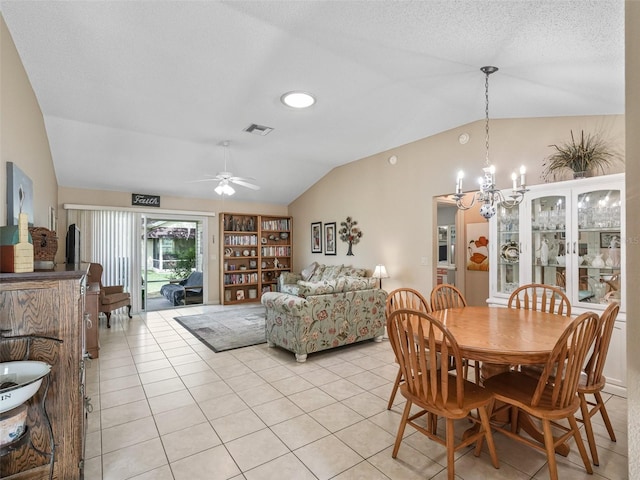 dining room featuring light tile patterned floors, visible vents, vaulted ceiling, and ceiling fan with notable chandelier