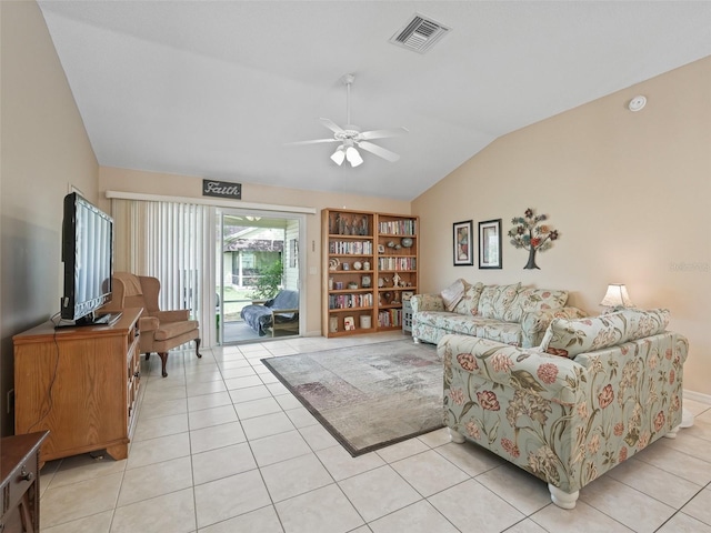 living area with light tile patterned floors, visible vents, ceiling fan, and vaulted ceiling