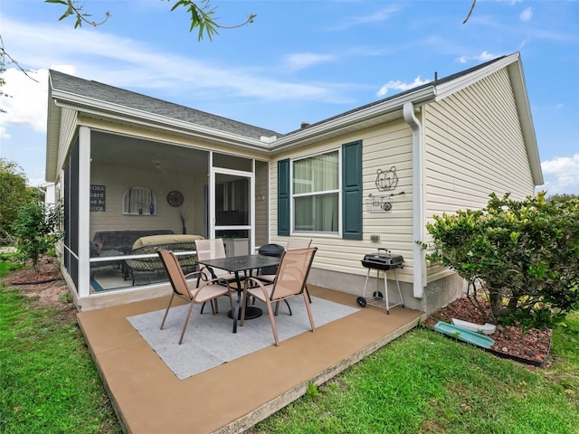 back of property featuring a sunroom and a patio area