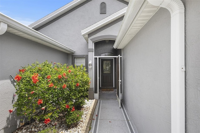 view of exterior entry with stucco siding