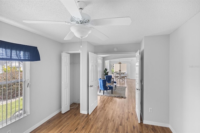 interior space featuring a textured ceiling, wood finished floors, and plenty of natural light