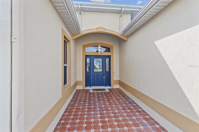 doorway to property featuring stucco siding