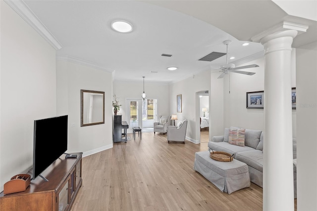 living area featuring baseboards, recessed lighting, ornamental molding, and ornate columns