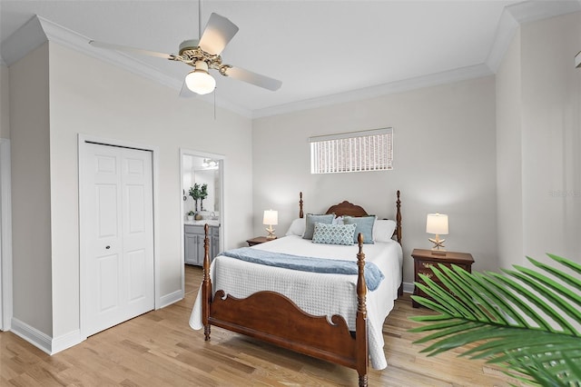 bedroom with a closet, baseboards, light wood-type flooring, ornamental molding, and a ceiling fan