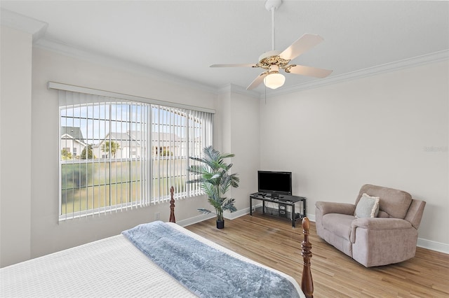 bedroom featuring baseboards, wood finished floors, multiple windows, and crown molding
