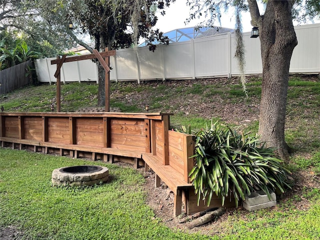1307 Rain Forest Ln, Minneola, FL 34715 - fenced backyard featuring a fire pit