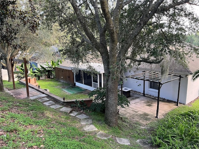 1307 Rain Forest Ln, Minneola, FL 34715 - back of property featuring a patio area, stucco siding, and a sunroom
