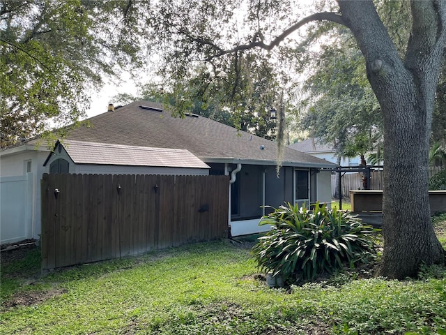 1307 Rain Forest Ln, Minneola, FL 34715 - back of house featuring roof with shingles and a sunroom