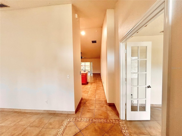 1307 Rain Forest Ln, Minneola, FL 34715 - hallway featuring light tile patterned flooring and baseboards