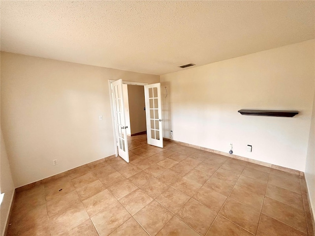 1307 Rain Forest Ln, Minneola, FL 34715 - empty room featuring french doors and a textured ceiling