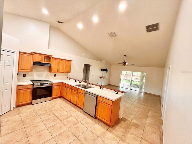 1307 Rain Forest Ln, Minneola, FL 34715 - kitchen with stainless steel appliances, a peninsula, under cabinet range hood, high vaulted ceiling, and a ceiling fan