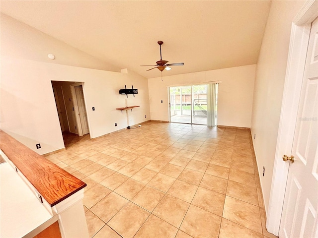 1307 Rain Forest Ln, Minneola, FL 34715 - spare room featuring vaulted ceiling, a ceiling fan, and light tile patterned floors