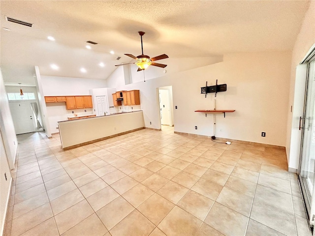 1307 Rain Forest Ln, Minneola, FL 34715 - kitchen featuring open floor plan, light tile patterned flooring, lofted ceiling, a ceiling fan, and a textured ceiling