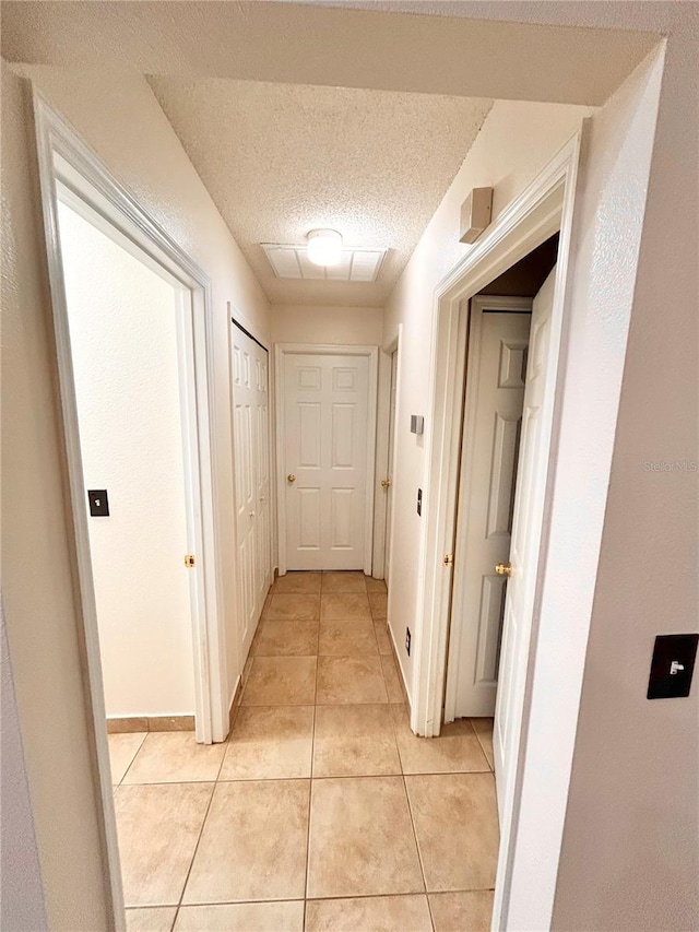 1307 Rain Forest Ln, Minneola, FL 34715 - hallway with light tile patterned flooring and a textured ceiling