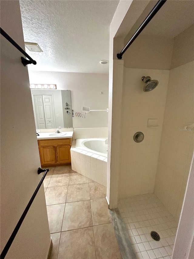 1307 Rain Forest Ln, Minneola, FL 34715 - bathroom featuring a garden tub, vanity, tile patterned flooring, and tiled shower