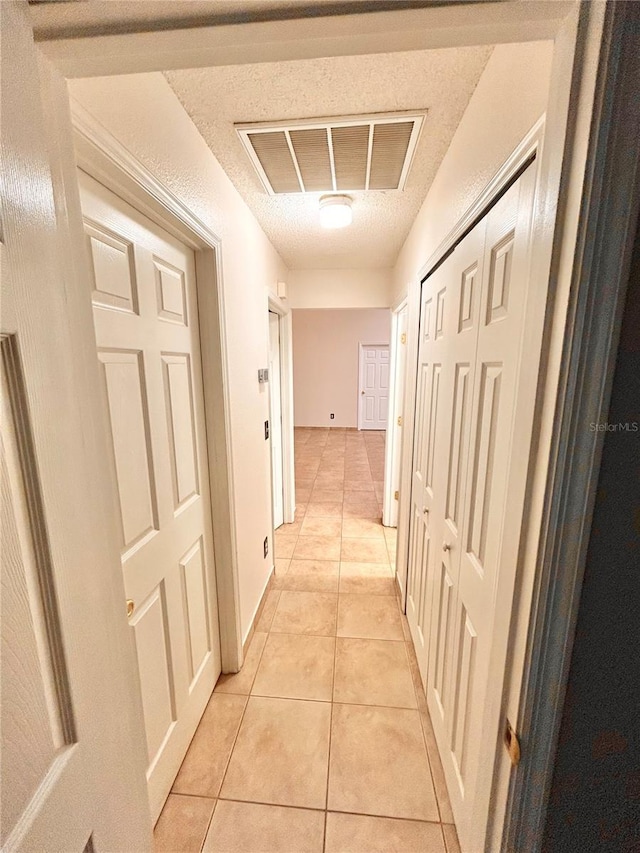 1307 Rain Forest Ln, Minneola, FL 34715 - corridor featuring light tile patterned flooring