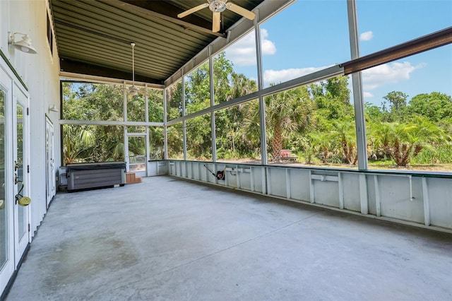 unfurnished sunroom featuring a ceiling fan