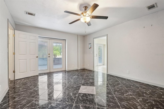 empty room featuring baseboards, ceiling fan, visible vents, and french doors