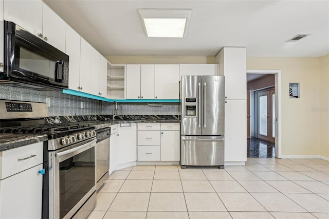 kitchen with stainless steel appliances, open shelves, visible vents, and tasteful backsplash