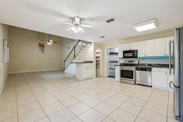 kitchen with ceiling fan, visible vents, dark countertops, tasteful backsplash, and stainless steel appliances