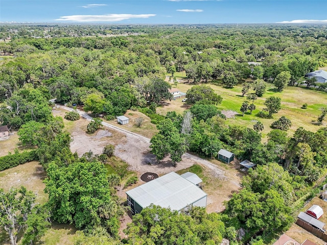 birds eye view of property with a forest view