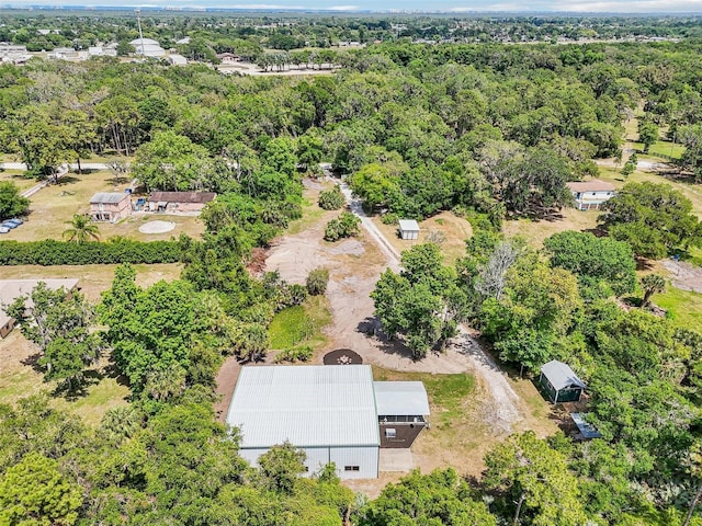 drone / aerial view featuring a wooded view
