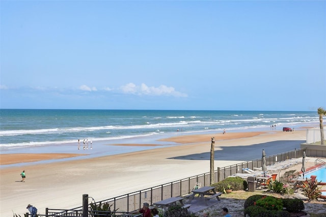 property view of water with a beach view and fence