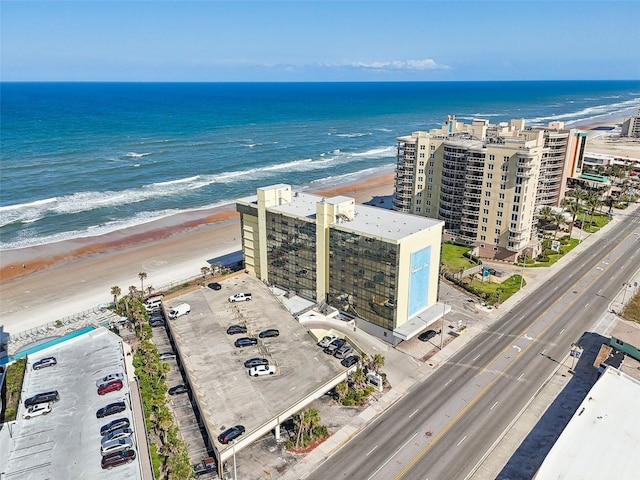bird's eye view featuring a water view and a beach view
