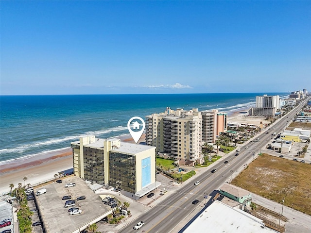 birds eye view of property featuring a view of city, a water view, and a view of the beach