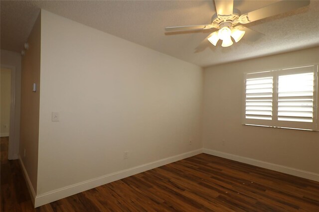 unfurnished room with baseboards, a ceiling fan, and dark wood finished floors