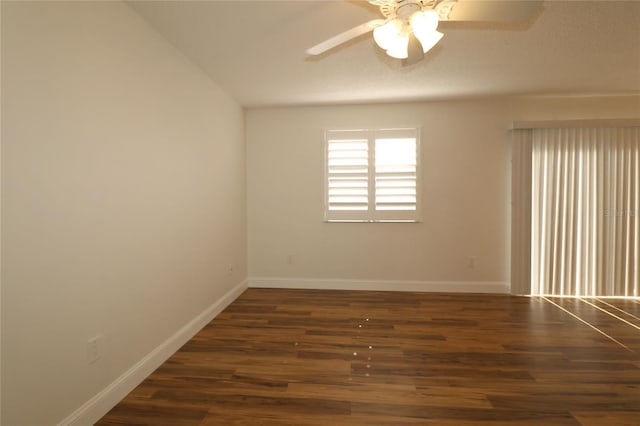 spare room with a ceiling fan, baseboards, wood finished floors, and lofted ceiling