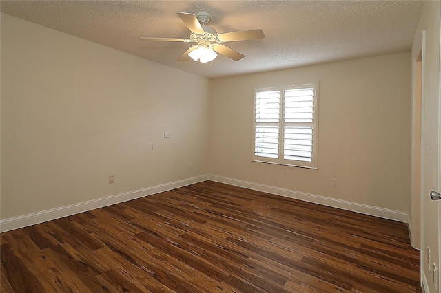 spare room with baseboards, ceiling fan, dark wood-style flooring, and a textured ceiling