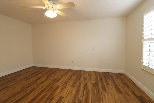 unfurnished room featuring baseboards, a ceiling fan, and wood finished floors