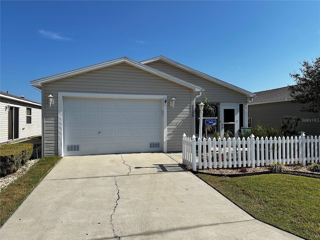 ranch-style house with a garage, fence, and driveway