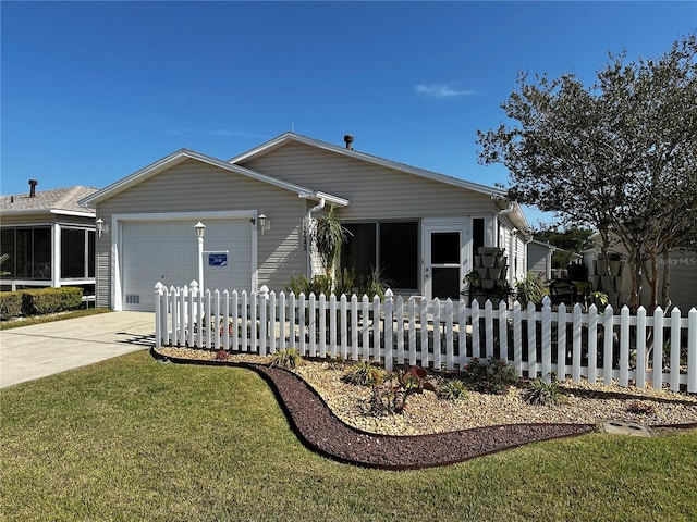 view of front facade with fence, an attached garage, and driveway
