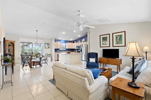 8097 SE 174th Belhaven Loop, The Villages, FL 32162 - living area with lofted ceiling, ceiling fan, light tile patterned floors, and a chandelier