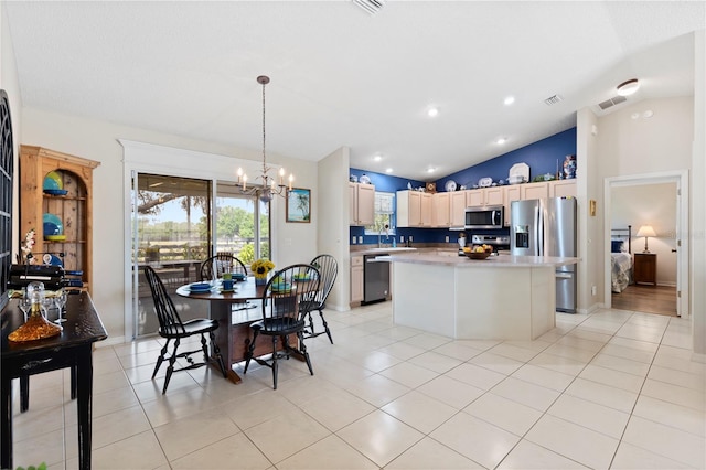 8097 SE 174th Belhaven Loop, The Villages, FL 32162 - kitchen featuring stainless steel appliances, a chandelier, lofted ceiling, a kitchen island, and light countertops