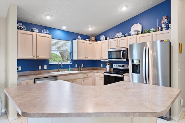 8097 SE 174th Belhaven Loop, The Villages, FL 32162 - kitchen with a sink, appliances with stainless steel finishes, a textured ceiling, light countertops, and a spacious island