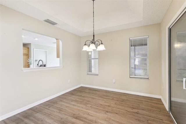 2139 Kaylee Dr, The Villages, FL 32162 - unfurnished dining area featuring wood finished floors, a chandelier, a sink, and baseboards