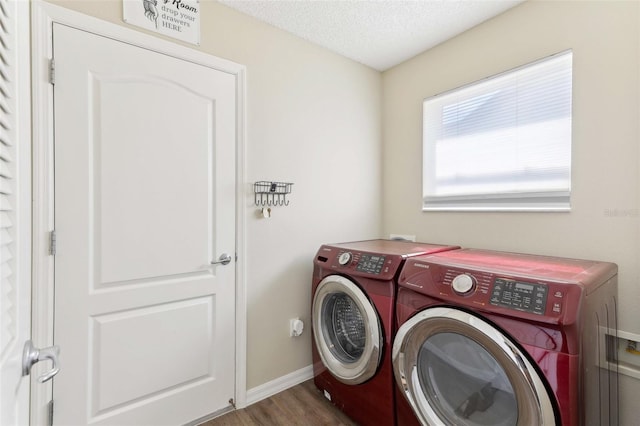 2139 Kaylee Dr, The Villages, FL 32162 - laundry area featuring washer and clothes dryer, wood finished floors, baseboards, and a textured ceiling