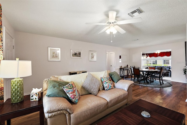 518 Alcazar Ct, The Villages, FL 32159 - living room with ceiling fan, visible vents, baseboards, a textured ceiling, and wood finished floors
