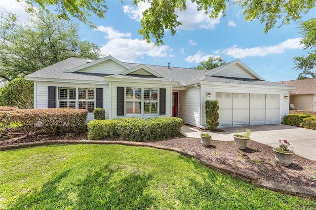 ranch-style home with concrete driveway, a garage, a front lawn, and a shingled roof