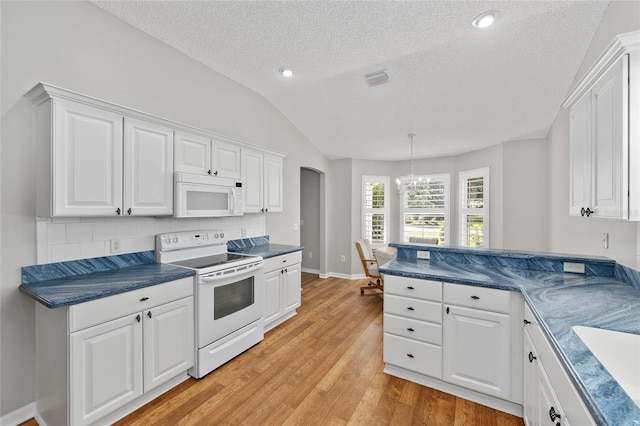 kitchen featuring a textured ceiling, white cabinetry, white appliances, and a notable chandelier