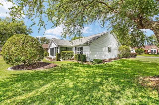view of side of property featuring a yard