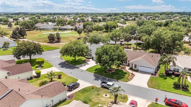 drone / aerial view featuring golf course view and a residential view