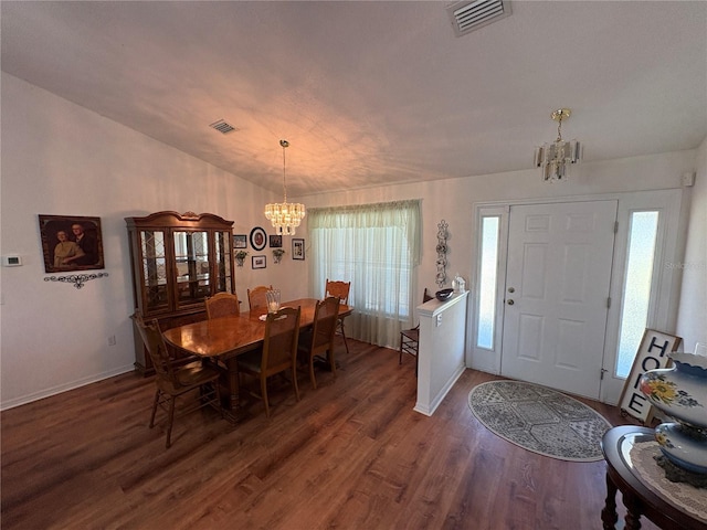 dining space with baseboards, visible vents, an inviting chandelier, and dark wood-style flooring